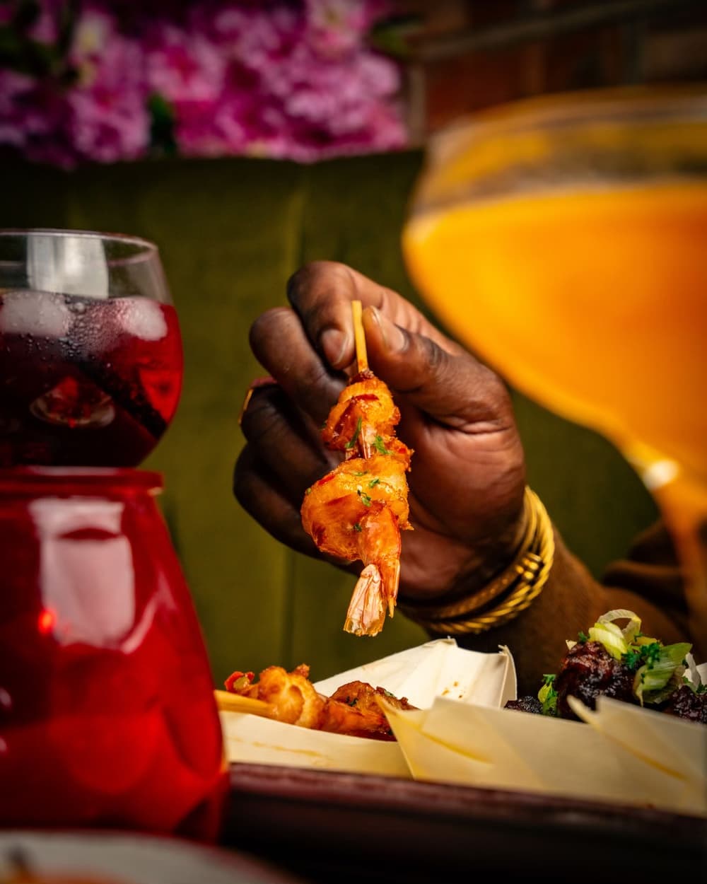 A prawn dish served beside cocktails at ESQ